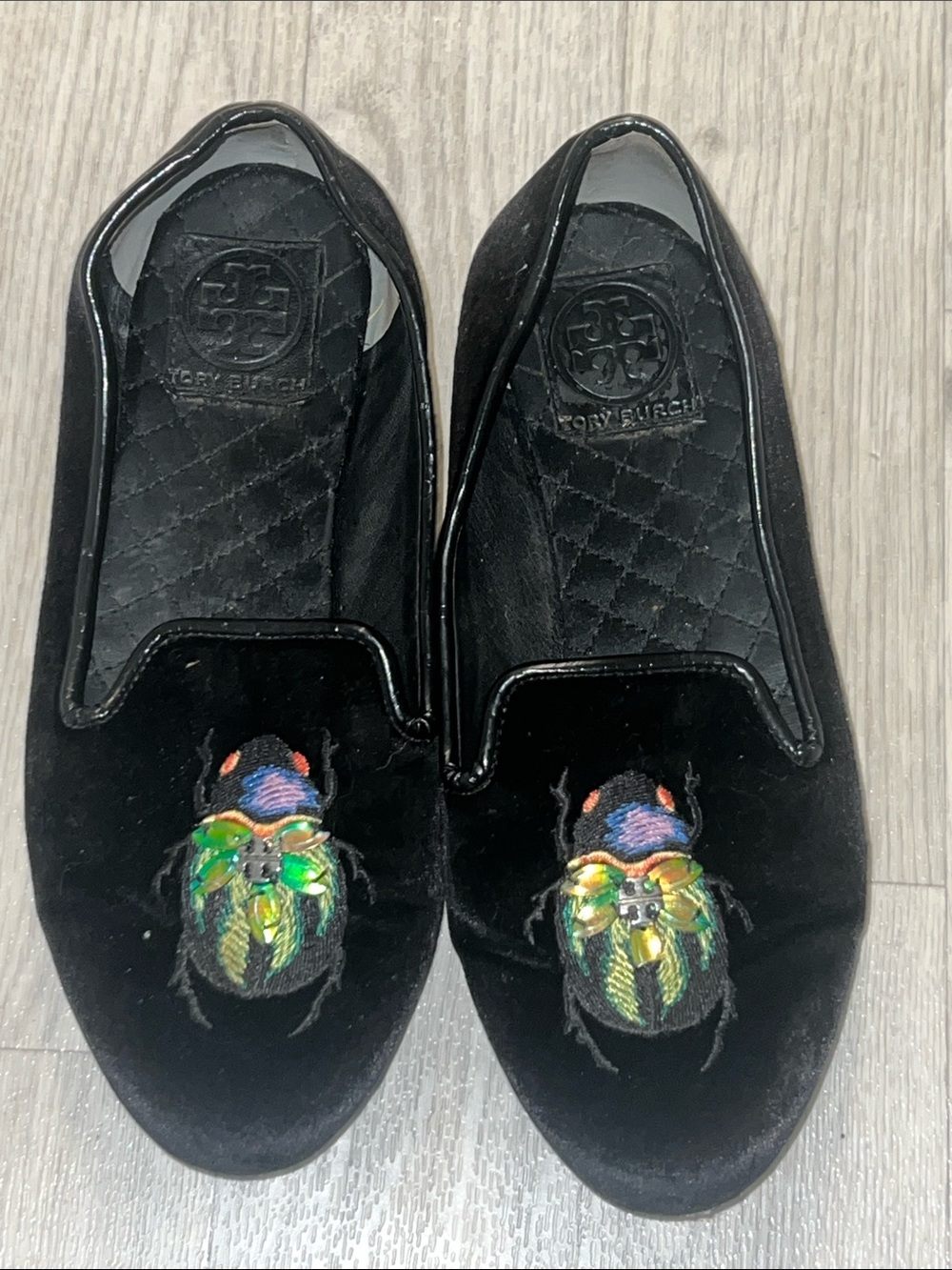 Tory Burch  Velvet Black Slip-on Flats with Multicolor Beetle Emblem.